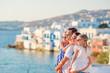Family in Europe. Parents and kids on Little Venice background on Mykonos Island, in Greece