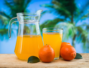 Wall Mural - orange juice in a glass on a table