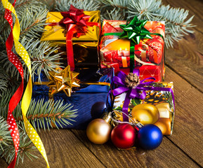 Christmas presents with christmas decorations on wooden backgrou