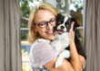 © adogslifephoto - Happy Woman and Little Dog in House