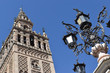 Detail view of the Giralda bell tower, Cathedral of Seville, Andalusia Antique street lamppost on square near historical building.