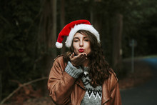 Young Woman With Santa Claus Hat Kissing