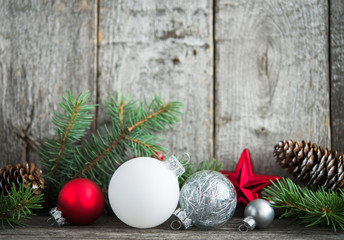 Wall Mural - Red, silver and white xmas ornaments on rustic wood background. Merry christmas card. Winter holiday theme. Happy New Year. Space for text.