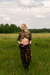 © jamurka - Attractive hunter girl with hunting double-barreled rifle looking out the trophy