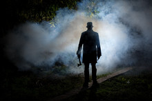 Spooky Man Wih Axe In The Dark Smoke Filled Forest