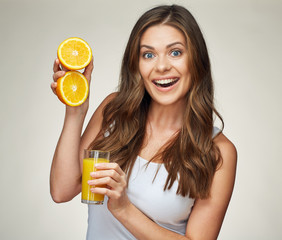 Wall Mural - smiling woman holding orange juice glass with half orange fruit.