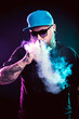 © mikhail_kayl - Men with beard  in sunglasses vaping and releases a cloud of vapor.