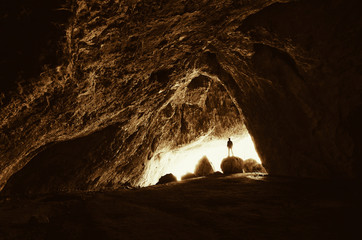 Wall Mural - cave explorer at cave entrance