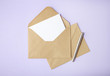 © beckystarsmore - An open brown envelope with letter and writing pen on a pastel purple background