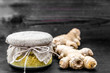 Grated ginger in a glass jar on dark background, spices in cuisine for cooking and treatment