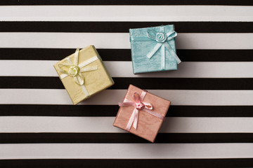 Wall Mural - small gift boxes on stripes paper background