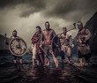 © Nejron Photo - A group of armed Vikings standing on river shore