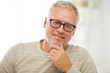 © Syda Productions - close up of smiling senior man in glasses thinking