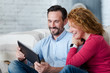 © zinkevych - Middle-aged couple using tablet at home