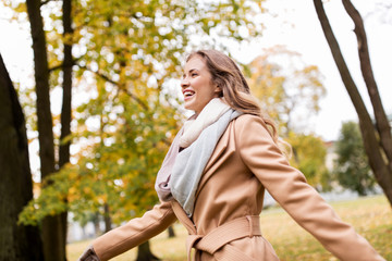 Sticker - beautiful happy young woman walking in autumn park