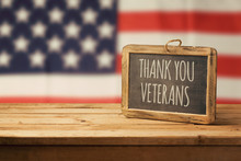 Veterans Day Background With Chalkboard On Wooden Table And USA Flag