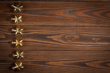 Christmas toys golden stars  on  wooden background concept Chris