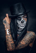 © Fxquadro - A woman with skull make up in top hat on Halloween.