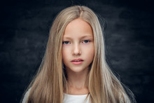 Studio Portrait Of Blonde Teenage Girl On Grey Background.