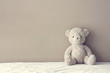 vintage teddy bear sit on the right side white bed at headboard