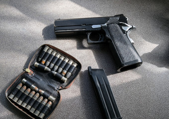 Pistol model magazine with bullets in bag on table