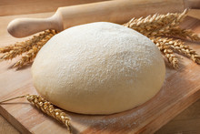 Fresh Dough On A Board With Ears Of Wheat And Rolling Pin.