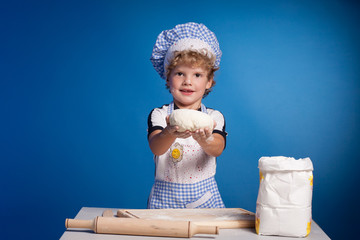 Little boy chef with flour dough and prepare pizza