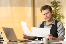 Businessman working comparing paper documents