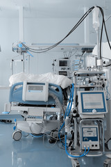 Wall Mural - Hospital bed, surrounded by a mass of medical equipment