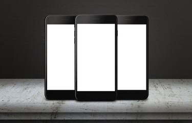 Poster - Three mobile phones on table with isolated display for mockup. Mobile app or web page presentation.