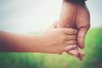 Close up of father holding his daughter hand, so sweet,family ti