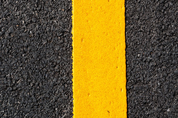 Yellow line on new asphalt detail,Street with yellow line texture