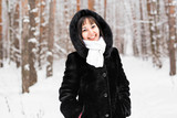 Fototapeta Koty - Attractive young woman in wintertime outdoor
