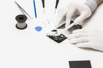 technician repairing broken mobile phone