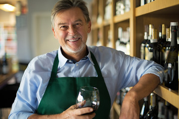 Wall Mural - Man working in wine shop 
