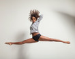 young beautiful dancer jump in a studio