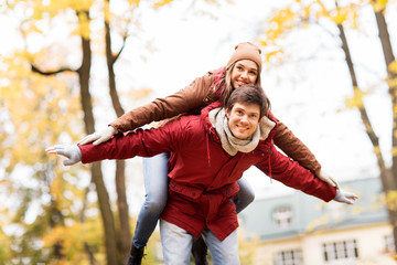 happy young couple having fun in autumn park