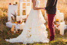 Bride And Groom At Outdoor Wedding Ceremony Decorations In The Autumn