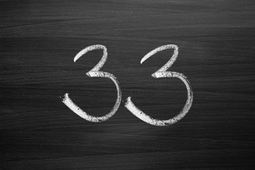 Wall Mural - number thirty three enumeration written with a chalk on the blackboard