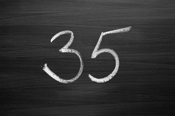 Wall Mural - number thirty five enumeration written with a chalk on the blackboard
