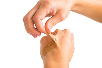 pluck medical plasters by hand. on white, isolated background.