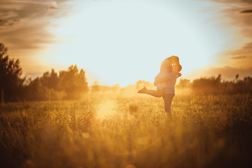 love story man and woman on the background of haystacks sun