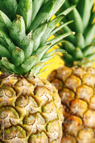 Ripe pineapples on a yellow wooden background
