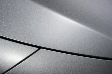 surface of metallic sport sedan car, detail of metal hood and fender of vehicle bodywork