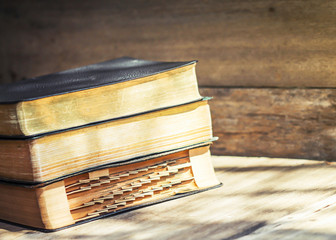 Poster - bibles on old wooden background with copy space