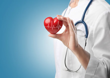 Cardiologist Holding Red Heart With Electrocardiogram. Cardiology Concept.
