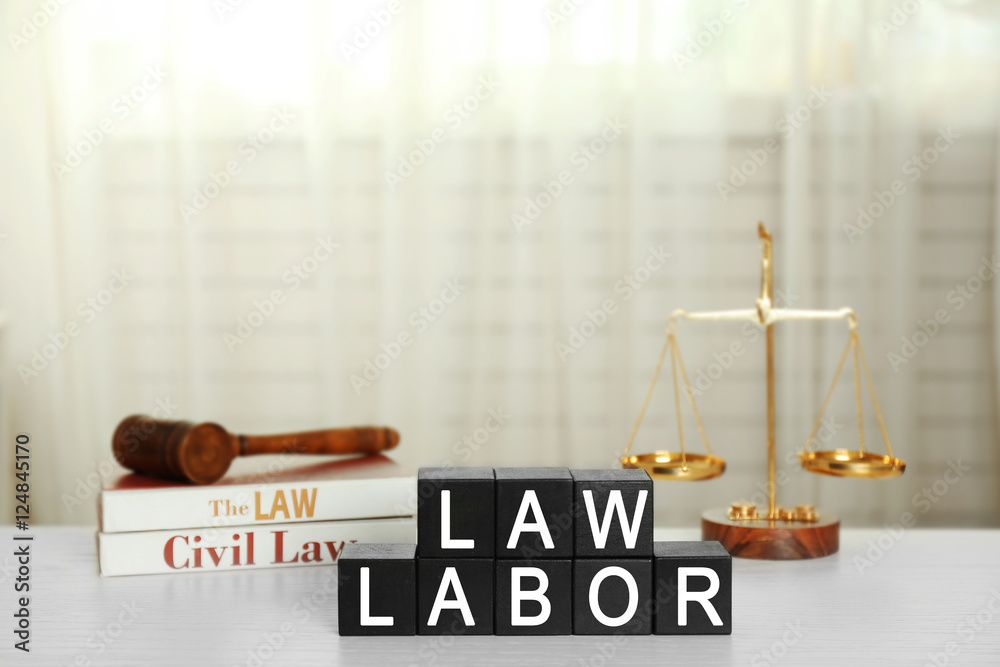 Black cubes with phrase LAW LABOR on white table