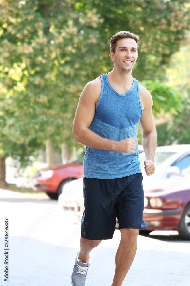 Young sportsman running in the street