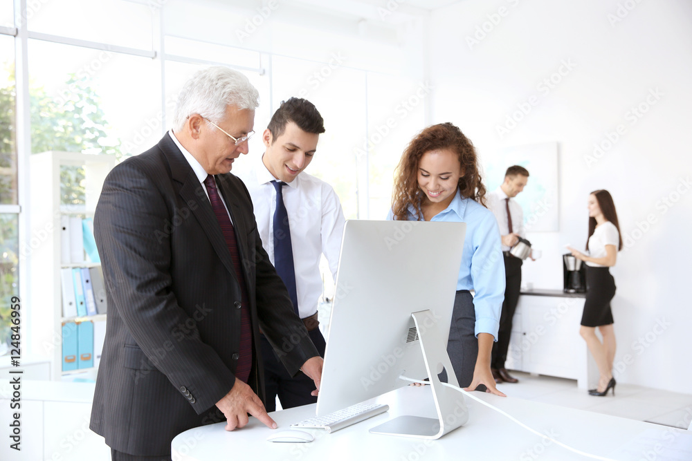 Business training concept. Colleagues looking at computer monitor in office