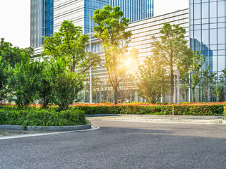 Sticker - empty asphalt road by modern office building.